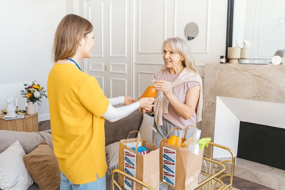 A support worker helping carry groceries to a car