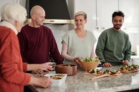 A family of different ages preparing a meal together in a home kitchen