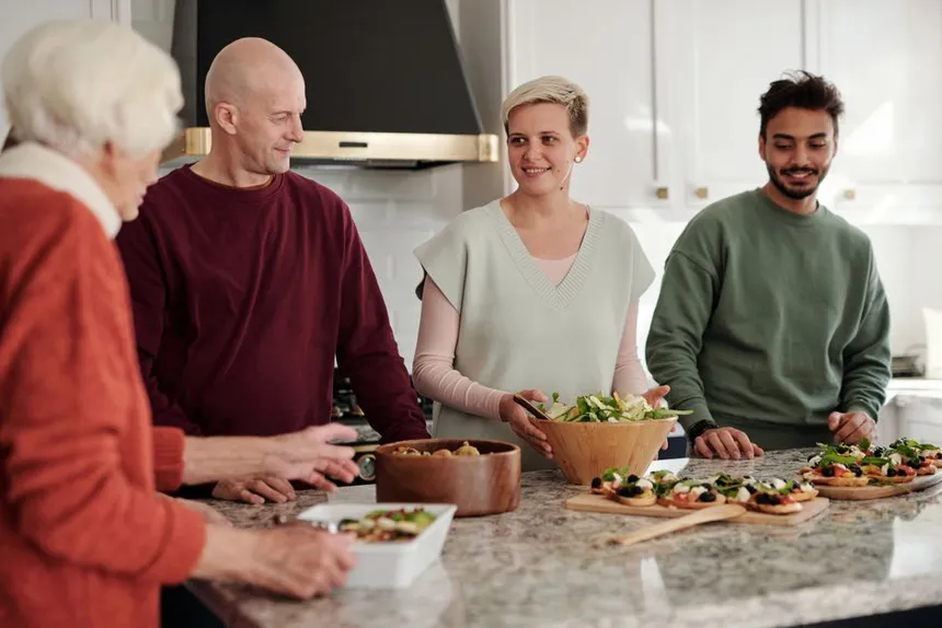 A family of different ages preparing a meal together