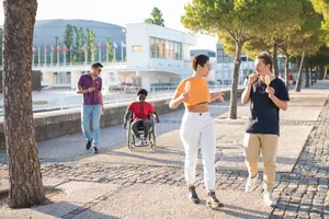 A group of friends walking together along a sunny street