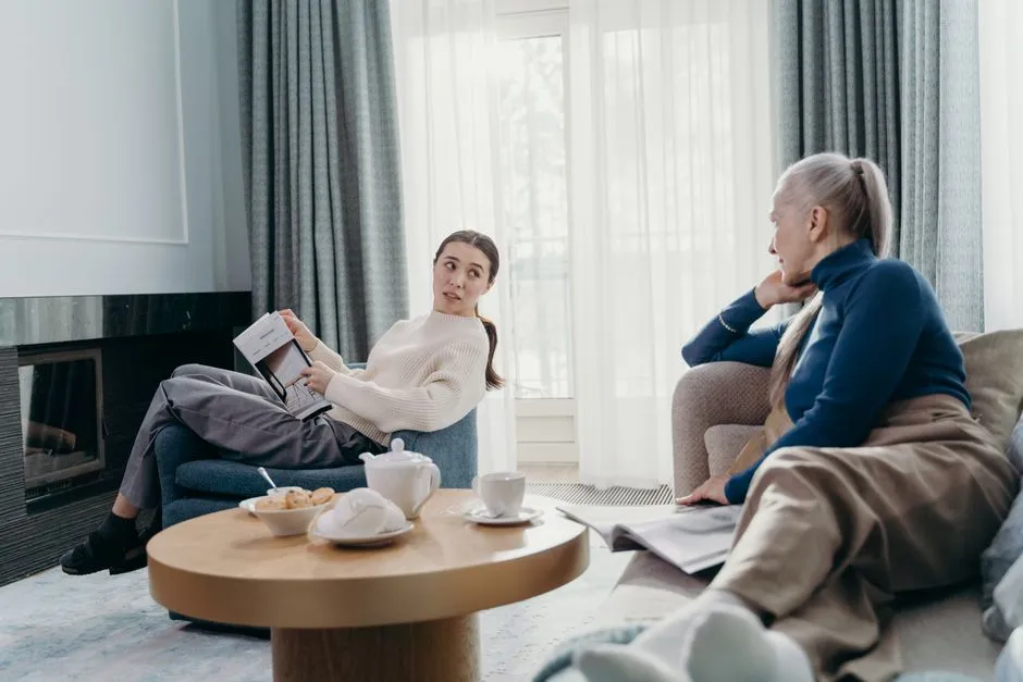 Two people working through a support plan together in a living room