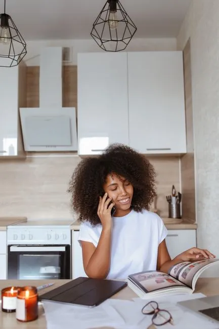 Two people talking through the first steps at a kitchen table